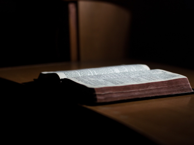 An open bible sitting on a table