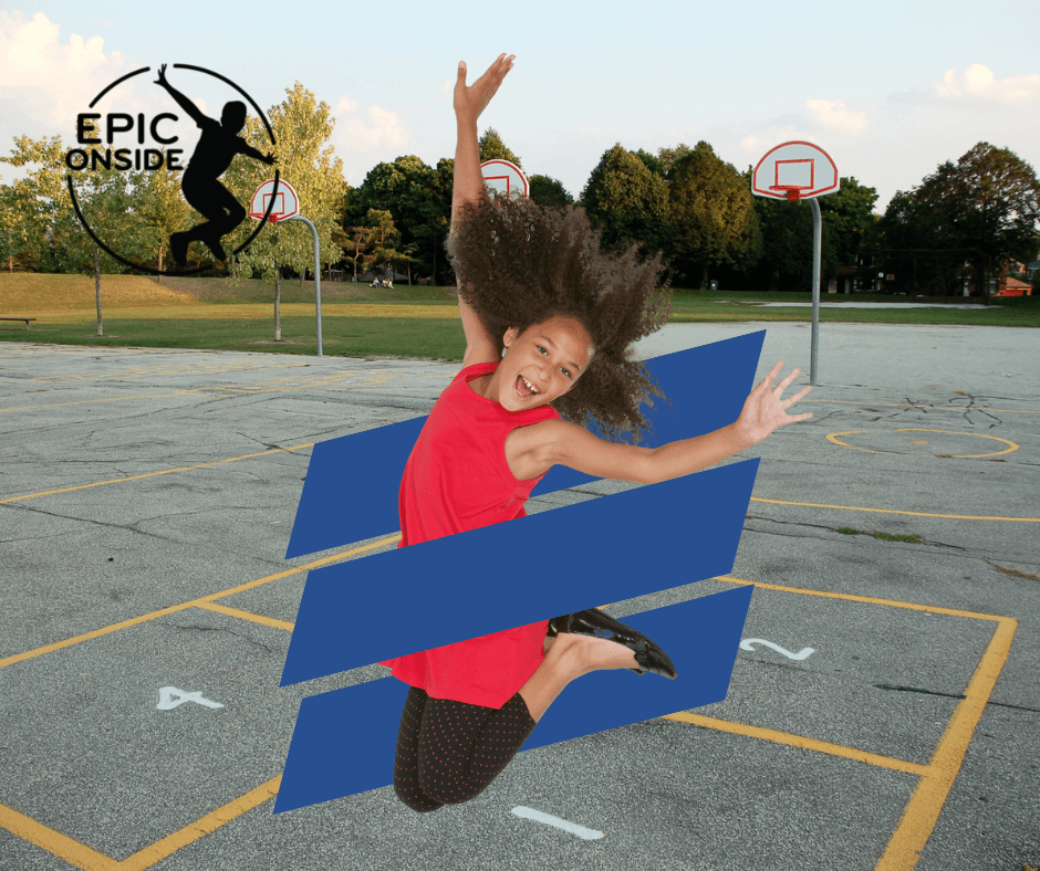 Little girl jumping exuberantly in a playground