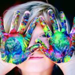 Little boy with paint on hands