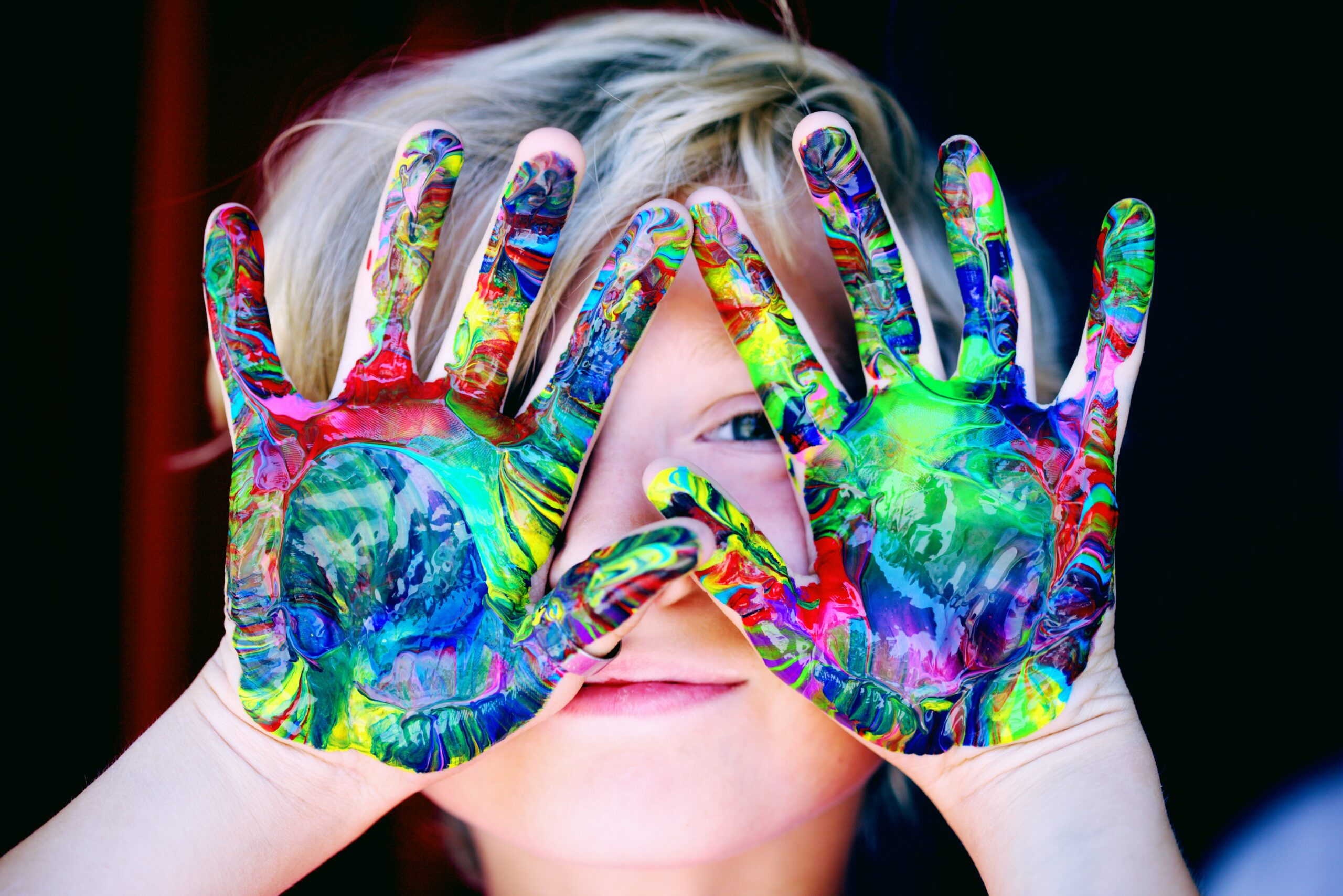 Little boy with paint on hands